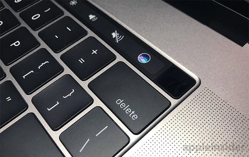 Image of the Mac keyboard and touchbar zoomed in on the backspace/"delete" key showing how close the Siri button is.