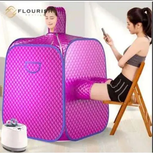 A large, purple cube made of nylon enclosing all but a woman’s smiling head. A slot in the side allows another person’s legs through.