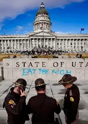 "EAT THE RICH" tagged on to the sign of the Utah State Capitol in Salt Lake City.